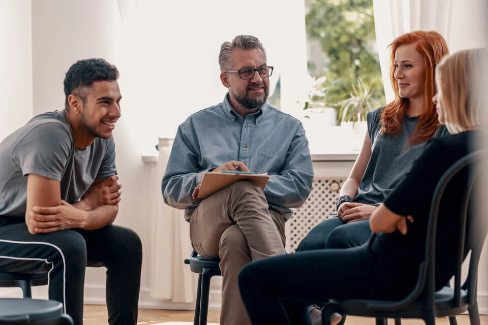 people gathering to discuss mental health and performance at work